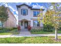 Two-story home with stone accents, manicured lawn, and inviting curb appeal at 5933 Caldera Ridge Dr, Lithia, FL 33547