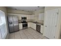 Bright kitchen featuring stainless steel appliances and ample cabinet space at 6213 Crickethollow Dr, Riverview, FL 33578