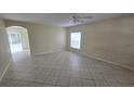 Spacious living room with neutral walls and tile flooring throughout at 6213 Crickethollow Dr, Riverview, FL 33578