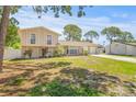 Beautifully maintained home featuring a two-car garage, mature trees, and a spacious front yard at 6607 Larimer Dr, Tampa, FL 33615