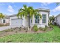 Beautiful single-story home features manicured lawn, gray tiled roof and lush landscaping at 7610 Addison Ave, Bradenton, FL 34210