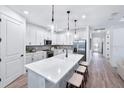Modern kitchen featuring white cabinets, a large island with seating, and stainless steel appliances at 7614 Addison Ave, Bradenton, FL 34210