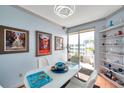 Bright dining area featuring a white table, stylish decor, and sliding glass doors leading to a balcony at 7922 Sailboat Key S Blvd # 608, South Pasadena, FL 33707