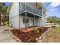 This exterior image shows a private patio area with outdoor seating and lush landscaping at 824 35Th Avenue W Dr, Palmetto, FL 34221
