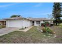 Inviting single-Gathering home with attached garage, complimented by mature trees and well-maintained landscaping at 8305 Palencia Dr, Port Richey, FL 34668