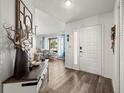 Bright foyer with hard wood floors, a decorative table, and a view into the living area at 9114 Dorsey St, Spring Hill, FL 34608