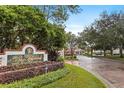 The Highlands Condominium Residences entrance sign with landscaping and a view of the community at 9481 Highland Oak Dr # 710, Tampa, FL 33647