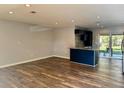 Open-concept kitchen and living area with stainless appliances and a breakfast bar at 9893 86Th N Way, Seminole, FL 33777