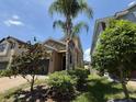 Eye-level front exterior shows stone accents and palm trees in the landscaped yard at 1022 Oliveto Verdi Ct, Brandon, FL 33511