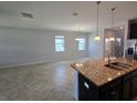 Open concept with granite countertops and dark cabinetry, seamlessly connecting to the living space at 1022 Oliveto Verdi Ct, Brandon, FL 33511