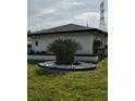 Exterior view of home showcasing the landscaped front yard, garden design, and curb appeal at 10430 42Nd N St, Clearwater, FL 33762