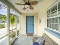 Charming front entrance with a cozy sitting area on the screened porch at 106 E Cedar St, Tarpon Springs, FL 34689