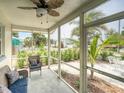 Relaxing screened porch with comfortable seating and views of the lush surroundings at 106 E Cedar St, Tarpon Springs, FL 34689