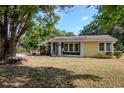 Single-story home with a screened porch, a mix of dark and bright exterior, and mature landscaping at 108 E Morgan St, Brandon, FL 33510