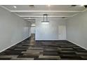 Spacious living room featuring hardwood floors and a modern chandelier at 12349 Wasatch Ct, New Port Richey, FL 34654