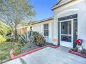 Inviting front porch with decorative plants, landscaping, and a view of the home's exterior at 12426 Dawn Vista Dr, Riverview, FL 33578