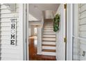 Welcoming foyer with hardwood floors and staircase leading to the upper level at 13310 Thoroughbred Loop, Largo, FL 33773
