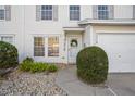 Close-up of townhouse entrance with a decorative wreath and well-kept landscaping at 13310 Thoroughbred Loop, Largo, FL 33773