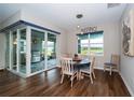 Bright dining area with sliding glass doors leading to an enclosed patio with a grill at 19877 Sea Glass Cir, Land O Lakes, FL 34638