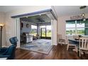 Casual dining area with views of the outdoor patio and a nearby pond at 19877 Sea Glass Cir, Land O Lakes, FL 34638