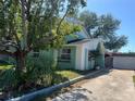 Exterior view of a charming home showcasing its unique facade and mature landscaping at 2068 San Marino N Way, Clearwater, FL 33763