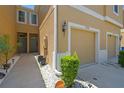 Close-up of two-story townhome exterior, attached garage and inviting front entrance with landscaping at 2234 Lennox Dale Ln, Brandon, FL 33510