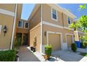 Two-story townhome featuring an attached garage and inviting front entrance with landscaping at 2234 Lennox Dale Ln, Brandon, FL 33510