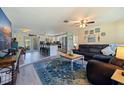 Spacious living room seamlessly flows into the kitchen featuring hardwood floors and tons of natural light at 2401 66Th S Ave, St Petersburg, FL 33712