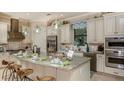 Well-equipped kitchen featuring an island with seating, modern appliances, and ample counter space at 29807 Imperati Blvd, Wesley Chapel, FL 33543
