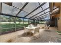 Enclosed lanai offering a great view of the yard with ample seating for relaxing and dining at 29903 Baywood Ln, Wesley Chapel, FL 33543
