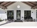 Inviting front porch with stylish seating and a welcoming entrance at 3440 Crenshaw Lake Rd, Lutz, FL 33548