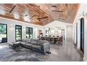 Spacious living room featuring hardwood ceiling, dining area and contemporary design at 3440 Crenshaw Lake Rd, Lutz, FL 33548
