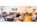 Cozy living room with plush furniture, decorative pillows, lamps, area rug, and a view into the dining area at 3505 Tarpon Woods Blvd # P408, Palm Harbor, FL 34685
