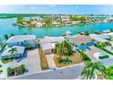 Beautiful waterfront property with lush landscaping, private dock, and serene water views at 365 La Hacienda Dr, Indian Rocks Beach, FL 33785