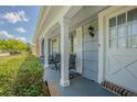 Inviting front porch with seating, columns and decorative trim at 4014 Pleasant Ridge Dr, New Port Richey, FL 34652