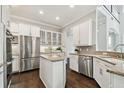 Beautiful kitchen featuring granite countertops, stainless steel appliances, and white cabinetry at 4206 W Sevilla St, Tampa, FL 33629