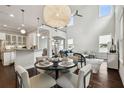 Bright living room featuring a contemporary light fixture, high ceilings, and modern furnishings at 4206 W Sevilla St, Tampa, FL 33629