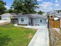 A charming single-story home featuring a lush green lawn and classic architectural details at 4465 56Th N Ave, St Petersburg, FL 33714