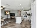Open concept kitchen and living room with granite countertops, stainless steel appliances, and hardwood flooring at 4465 56Th N Ave, St Petersburg, FL 33714