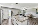 Open-concept kitchen and living area boasts an island and lots of natural light at 4465 56Th N Ave, St Petersburg, FL 33714