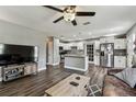 Open floor plan view of the kitchen and living room with wood flooring and grey walls at 4465 56Th N Ave, St Petersburg, FL 33714
