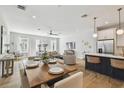 Spacious open-concept layout featuring a dining area, kitchen, and living room with modern furnishings at 4757 Legacy Park Dr, Tampa, FL 33611