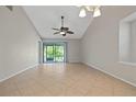 Bright, spacious living room with neutral tile floors and sliding glass doors to the patio at 5100 Burchette Rd # 3005, Tampa, FL 33647