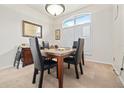Bright dining room with large window and shutters, featuring a wood table with seating at 6237 Greenwich Dr, Tampa, FL 33647