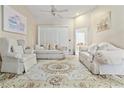Bright living room with vaulted ceilings, plush furnishings, and a neutral color palette at 6237 Greenwich Dr, Tampa, FL 33647
