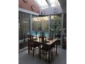 Bright dining area with a skylight, tiled floor, and views of the outdoor pool at 625 Fayette S Dr, Safety Harbor, FL 34695