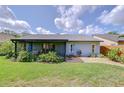 Expansive backyard with lush greenery, patio area, and well-maintained lawn perfect for outdoor living at 7107 Colonial Lake Dr, Riverview, FL 33578