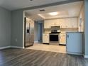 This spacious kitchen features white cabinets, stainless steel appliances, and tile flooring at 7510 Sequoia Dr, New Port Richey, FL 34653