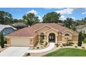 Beautiful single-story home featuring lush landscaping and a welcoming entrance at 9346 Southern Belle Dr, Weeki Wachee, FL 34613