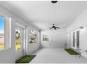 Bright and airy sunroom featuring lots of natural light, ceiling fan, and entry to the outdoor area at 100 18Th Nw St, Ruskin, FL 33570